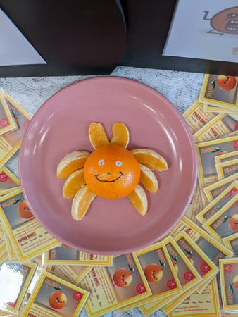 Smiling crab made from orange slices and fruit cards