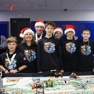 Team of six students with one advisor pose with their lego creations