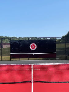 HASD Tennis Court with Black practice backboard and HASD logo in the background